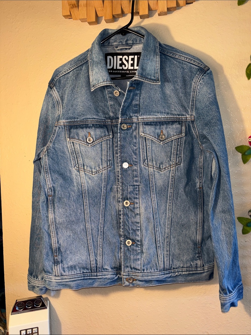 EUC Diesel Nhill denim jacket featuring a classic button-front design and signat